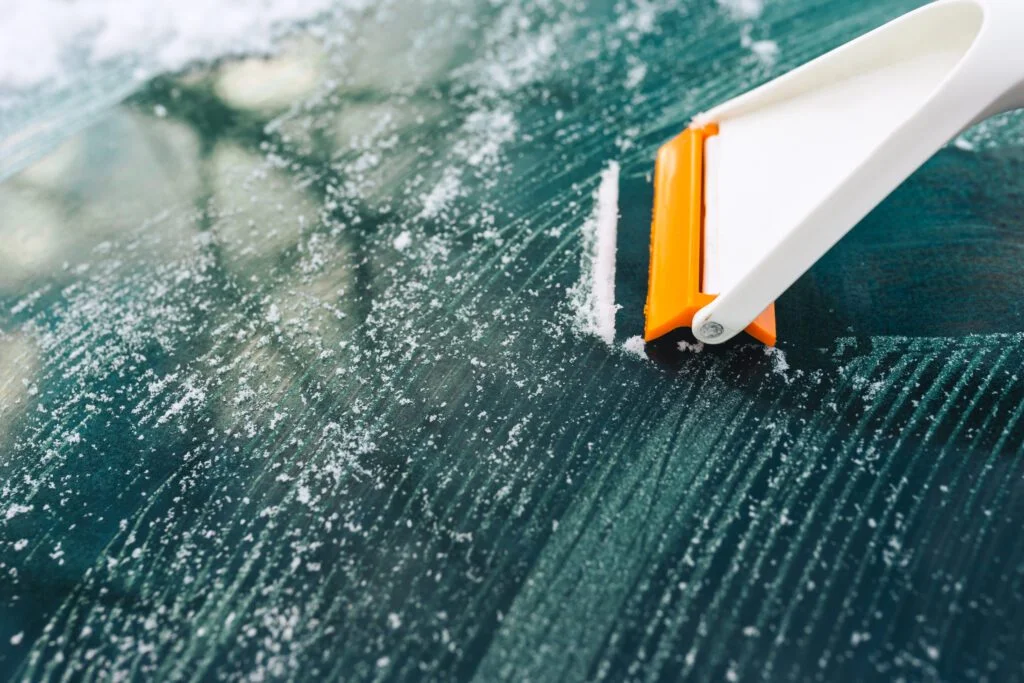 cleaning auto glass from ice with a scraper close 2023 11 27 04 51 34 utc No.1 Best in Auto Glass Repair in Irving TX- Carmex Inc.